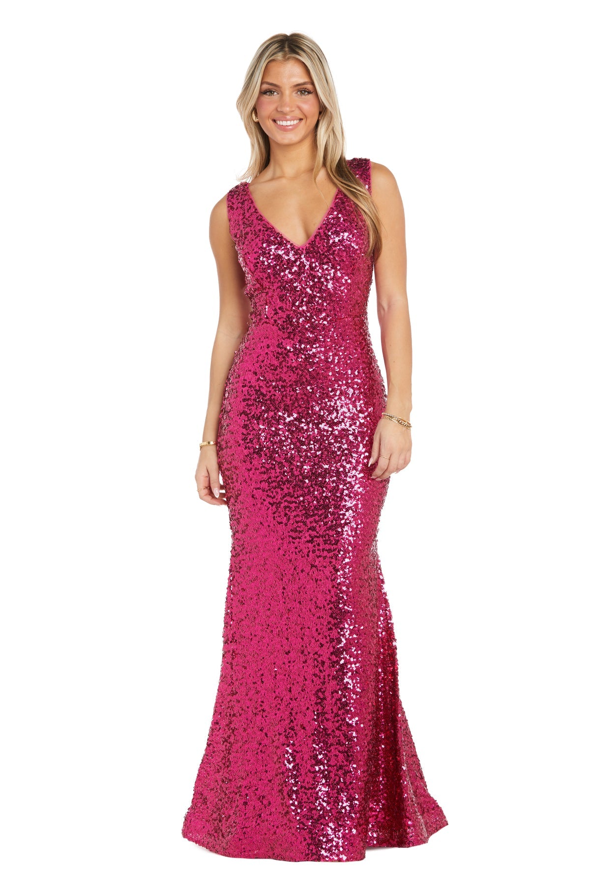 Woman wearing the Long Sequin Prom Dress: Morgan 13313, a floor-length, sleeveless sequin gown with a mermaid silhouette and V-neckline, standing and smiling.